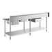 A Regency stainless steel work table with 2 sinks on the right.