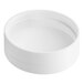 A white round plastic spice container with a white lid on a white surface.