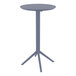 A Siesta Sky round dark gray table with a metal base.