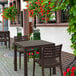 A Siesta Ares brown square table and chairs on an outdoor stone patio.