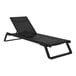 A Siesta Tropic black resin outdoor chaise lounge with black sling on a white background.