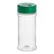 A clear plastic round spice container with a green lid.