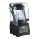 A black Vitamix blender with a clear sound enclosure container on a counter.