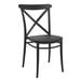 A Siesta Cross black resin outdoor dining chair with a cross back.