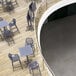 A dark gray Siesta Sky bar height folding table on a wood floor.