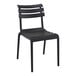 A Siesta Helen black resin outdoor dining chair with a slatted back.