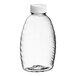 A clear plastic Classic Queenline honey bottle with a white plastic flip top lid.