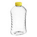 A clear plastic Ribbed Hourglass PET honey bottle with a yellow flip top lid.