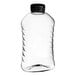 A clear plastic ribbed hourglass honey bottle with a black plastic flip top lid.
