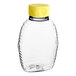 A clear plastic bottle with a yellow lid.