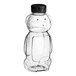 A clear plastic Bear PET honey bottle with a black flip top lid.