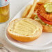 A plate of food with a Sweet Baby Ray's Honey Mustard Dipping Sauce-covered sandwich and fries.