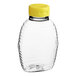 A clear plastic bottle with a yellow lid.