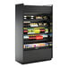 A black Structural Concepts Oasis air curtain merchandiser with shelves of drinks.