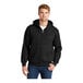 A man wearing a CornerStone black full-zip hooded sweatshirt with thermal lining.
