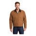 A man wearing a CornerStone brown duck cloth work jacket with a black corduroy collar.