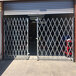 An Illinois Engineered Products heavy-duty galvanized steel folding double security gate installed in a garage.