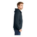 A person wearing a CornerStone navy hooded sweatshirt.