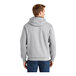 A person wearing a CornerStone unisex athletic heather grey full-zip hooded sweatshirt.
