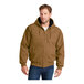 A man wearing a CornerStone brown insulated hooded work jacket.