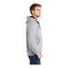 A man wearing a CornerStone athletic heather full-zip hooded sweatshirt with thermal lining.
