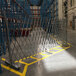 An Illinois Engineered Products heavy-duty galvanized steel folding access control gate in a warehouse.