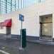 An Illinois Engineered Products heavy-duty galvanized steel folding security gate in front of a building.