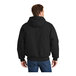 A man wearing a CornerStone black washed duck cloth hooded work jacket.