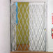 A door with a metal Illinois Engineered Products folding security gate.