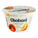 A white Chobani container of peach Greek yogurt with a peach slice on the label.