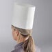 A woman wearing a white Choice chef hat.