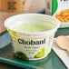 A green bowl filled with Chobani Key Lime Greek Yogurt on a white tray.