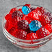 A bowl of Albanese gummy candies in red, blue, and black.