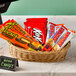 A basket of HERSHEY'S King Size Chocolate Candy Bars on a table.