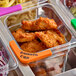 A container of food in a metal container with an orange Choice label.