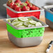 A Vigor Green stainless steel food pan with sliced cucumbers and a marker.
