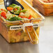 A Vigor beige blank write-on high-heat food pan label in a container of vegetables with a spoon.