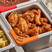 A Vigor orange write-on label on a tray of chicken wings and pasta.