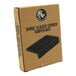 A black rectangular Rhino Coffee Gear classic corner tamper mat on a brown surface.