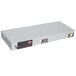 A white rectangular metal box with a black label and red lights.