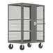 A grey Valley Craft security cart with a metal cage on wheels.