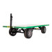 A green Valley Craft quad-steer trailer with black wheels.