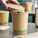 A 32 oz. kraft paper food cup with a vented lid labeled as compostable.