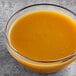 A bowl of Endless Harvest peach puree on a table.