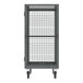 A gray metal security cart with shelves and bars on wheels.