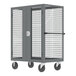 A grey Valley Craft security cart with shelves and a cage on wheels.