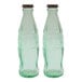 Two green glass Coca-Cola bottles with stainless steel tops.