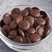 A bowl of Guittard Sante 72% Coconut Sugar Dark Chocolate wafers.