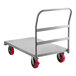 A gray metal platform truck with red wheels.