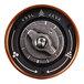 A close-up of the round metal button on a VSSL Java coffee grinder.